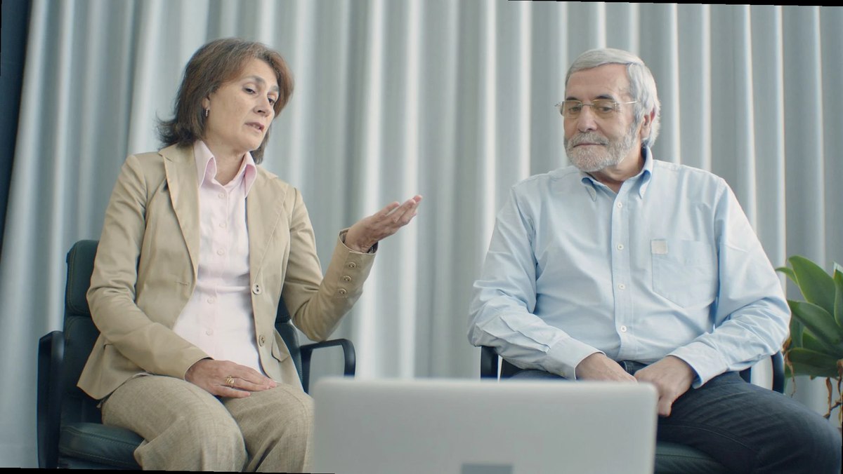 pareja madura consultando información médica en casa